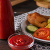 Thick, rich South African tomato sauce in a clear glass bowl showcasing its deep red color and smooth texture