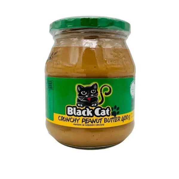 Black Cat Peanut Butter Crunchy 400g jar with roasted peanuts on a wooden surface