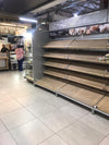 Empty shelves in a South African grocery store showing limited stock availability