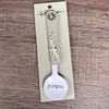 Enamel sugar spoon with wooden handle and laser engraved birds on a wire design
