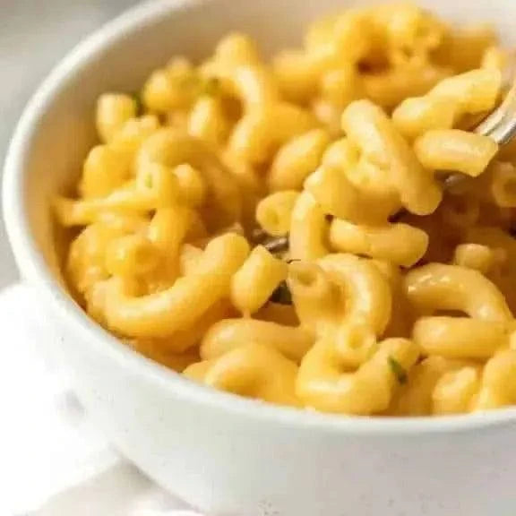 Bowl of cooked macaroni noodles with a fork.