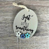 Wooden gift tag with "Just A Little Something" text