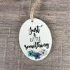 Wooden gift tag with "Just A Little Something" text