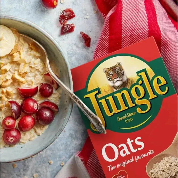 Jungle Oats 1kg beside a bowl of wholegrain oats and red berries