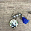 Wooden circle key tag with black and white cow and navy tassel