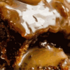 Moist sponge-like sticky toffee pudding topped with rich toffee sauce and served with cream