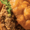 Golden fried vetkoek bread balls on a white plate