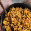 Traditional Nguni samp and beans dish with spices and sauces in a bowl