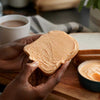 South African cheese spread jar with crackers and bread on wooden board