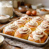 Close-up of soft cinnamon rolls with cream cheese frosting, showcasing New Zealand-style baking and ingredient quality.