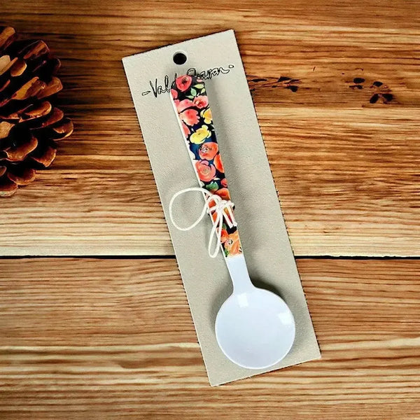Enamel printed sugar spoon with black floral design and wooden handle